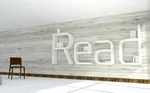 Ein moderner Raum mit Stulh und einem Bücherregal aus den Buchstaben "READ".