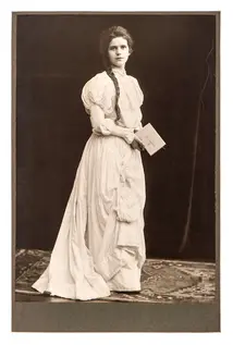 Young woman in vintage dress posing with bible book. antique picture from ca. 1900.