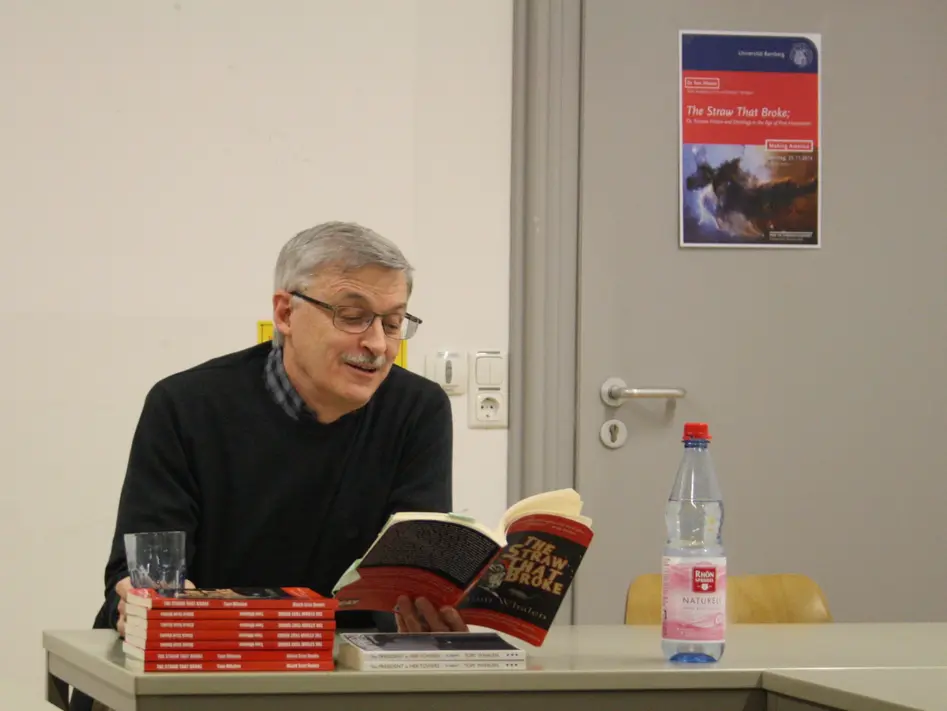Photo of Dr. Tom Whalen reading from his book.