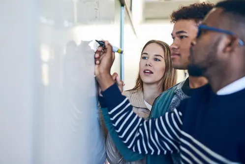 University, whiteboard and teacher with students in class writing for math lesson, learning and exam. Education, teaching and learners with equation for knowledge, assignment and study in college