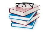 glasses on a pile of books