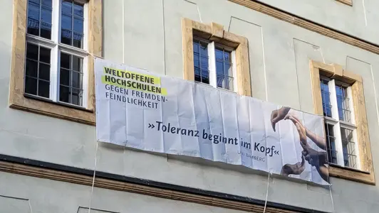 Banner an Universitätsgebäude mit der Aufschrift: "Toleranz beginnt im Kopf".