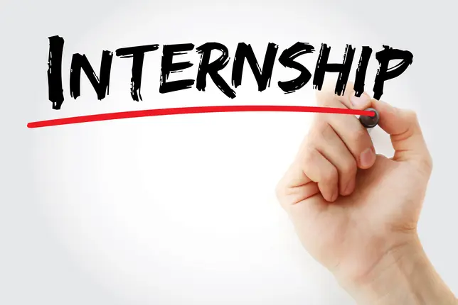 The photo shows the word "internship" and a hand that is underlining it in red.