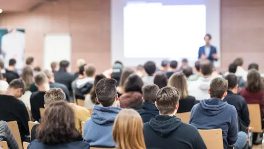 Business speaker giving a talk at business conference event.