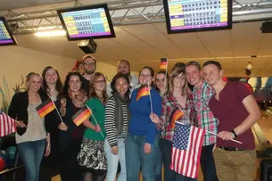 Photos of participants of “Bamberg Buddies” at the Bowling alley, ice skating and watching a basketball match in the Brose Arena in Bamberg.