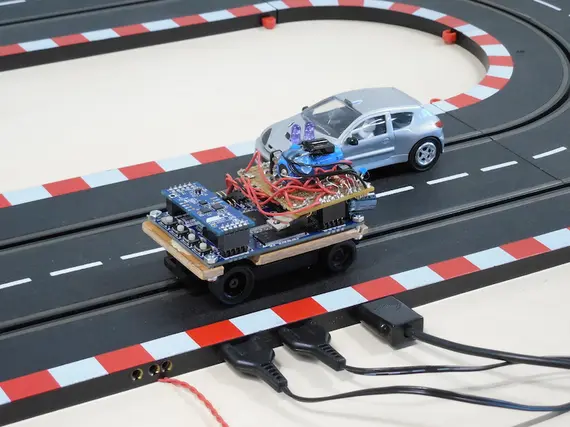 picture of slot car prototype on the tracks, a manually controlled slot car on the second track