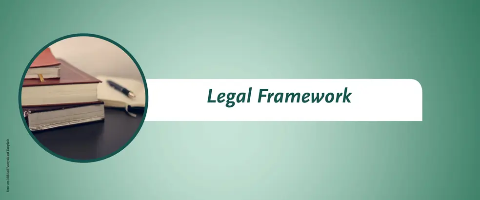 This is a banner with a green background for the 'Legal Framework' page. In a circular image, it shows three stacked books and an open book with a pen on top of the open book.