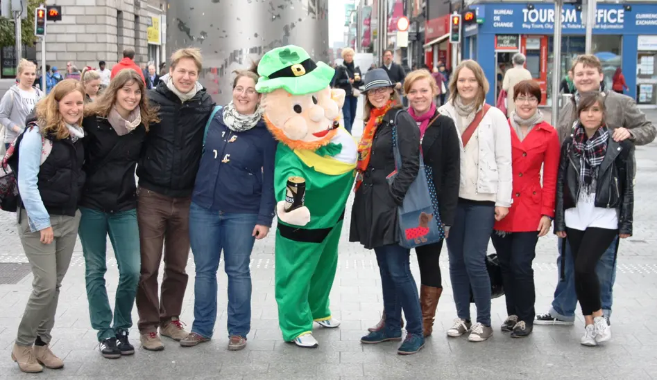 Group photo of the seminar members. They are posing with a person dressed as a leprechaun.