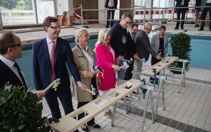 Das alte Hallenbad wird zum Universitätssportzentrum. Der Hammerschlag leutete den offiziellen Baubeginn ein. Dabei waren (v.l.n.r.): Ulrich Delles, Leiter des Staatlichen Bauamts Bamberg, Jonas Glüsenkamp, Zweiter Bürgermeister der Stadt Bamberg, Dagmar Steuer-Flieser, Kanzlerin der Universität, Melanie Huml, bayerische Staatsministerin für Europaangelegenheiten und Internationales, Markus Blume, bayerischer Staatsminister für Wissenschaft und Kunst, Kai Fischbach, Präsident der Universität Bamberg, Holger Dremel, Mitglied des bayerischen Landtags, sowie Heidrun Piwernetz, Regierungspräsidentin von Oberfranken. 