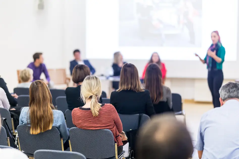 Woman giving presentation on business conference workshop.