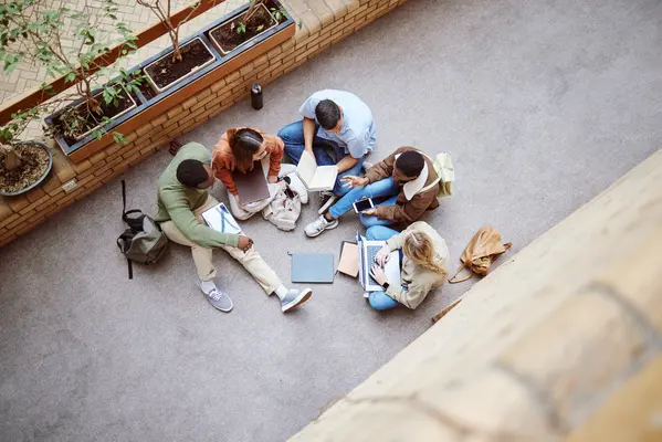University, group collaboration and students working on research, college project or education study. Knowledge learning, teamwork meeting and top view of diversity people coworking on school floor