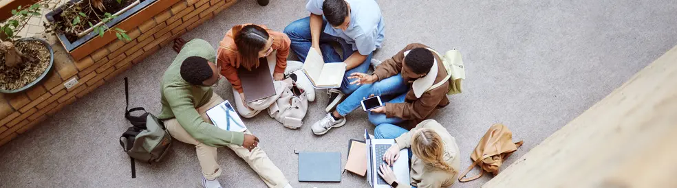 University, group collaboration and students working on research, college project or education study. Knowledge learning, teamwork meeting and top view of diversity people coworking on school floor