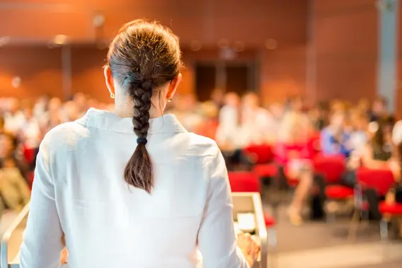 Female academic professor lecturing at the faculty.