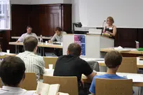 Impressions of attendees listening to speakers, discussing, sitting in a beer garden and exploring Bamberg.