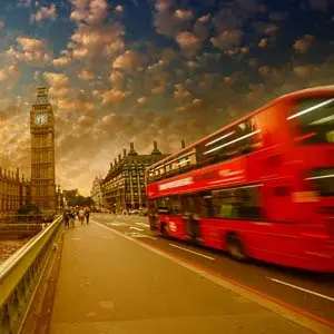 Westminster Bridge traffic at sunset. Blurred Red Bus crossing the street