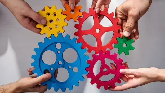 Business team connect pieces of gears. Teamwork, partnership and integration concept
