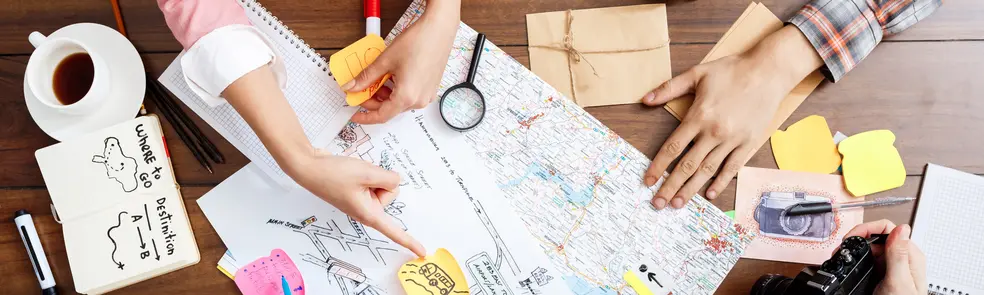 Picture of businessmen's hands on wooden table with documents and drafts