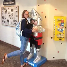 Photo of Nicole Konopka hugging a life-size Playmobil knight.