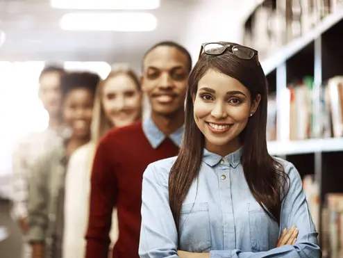 Portrait, smile and friends learning at library for education, knowledge or test preparation in college. University students, woman and confidence for studying, project notes and exam report