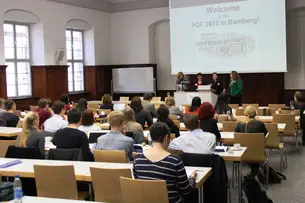 Impressions of attendees sitting and listening to speakers.