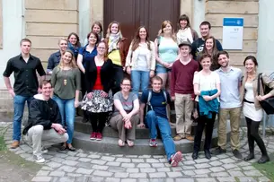 Photos in participants of “Bamberg Buddies” sitting in a pub getting to know each other.