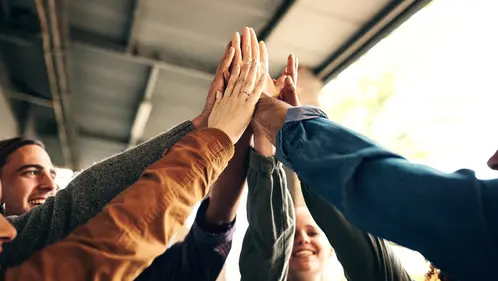 Happy, students and high five for teamwork outdoor with education success, learning achievement and studying. Collaboration, people and celebration for knowledge goals, partnership and university Happy, students and high five for teamwork outdoor with education success, learning achievement and studying. Collaboration, people and celebration for knowledge goals, partnership and university