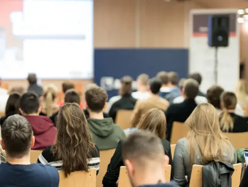 Female speaker giving presentation on business conference.