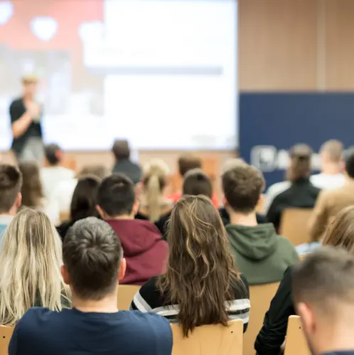 Female speaker giving presentation on business conference.