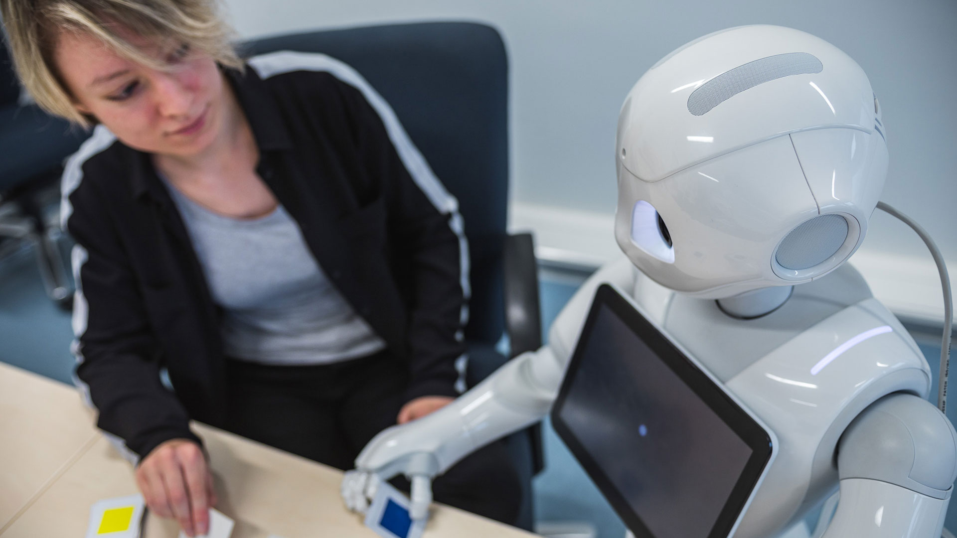 Studentin am Forschen mit dem Roboter namens Pepper